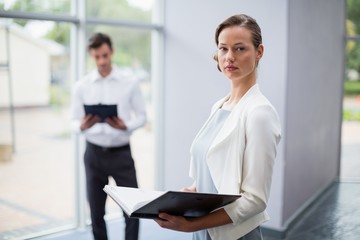 Businesswoman holding a file at conference centre
