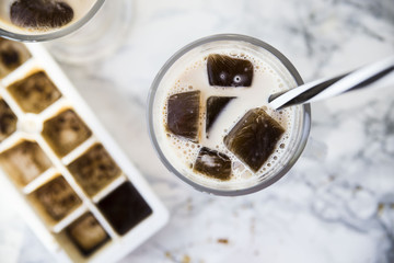 frozen coffee cubes with milk - cocktails on marble table