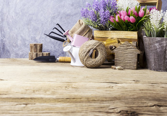 Home and garden concept of gardening tools and flowers on the old wood
