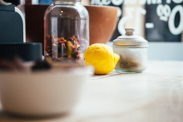 Lemon and spices in containers in daylight