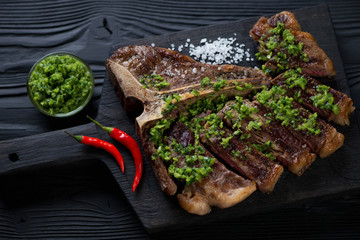 Sliced bbq club beefsteak served with chimichurri sauce