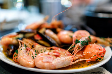 Shrimp, crayfish and mussels are on the big dish in the sauce.