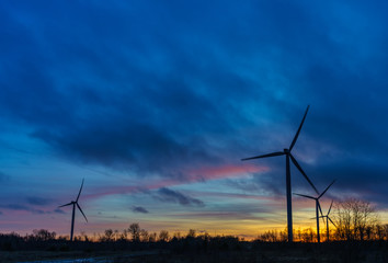 Wind turbine power generators silhouettes,sunset