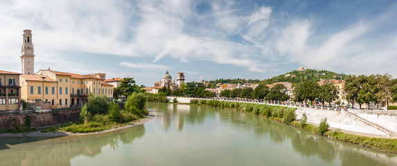 Fototapeta na wymiar Sunny panoramic view of Adige river from Stone Bridge (Ponte di Pietra) in Verona, Veneto region, Italy.
