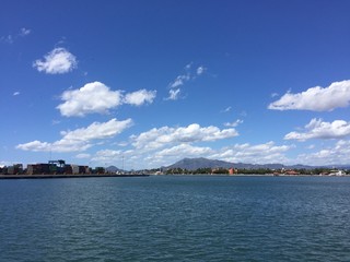 blue sky with cloud patches and sea