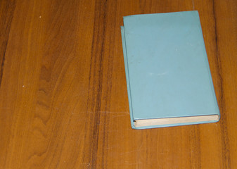 Fototapeta premium Old book on wooden table