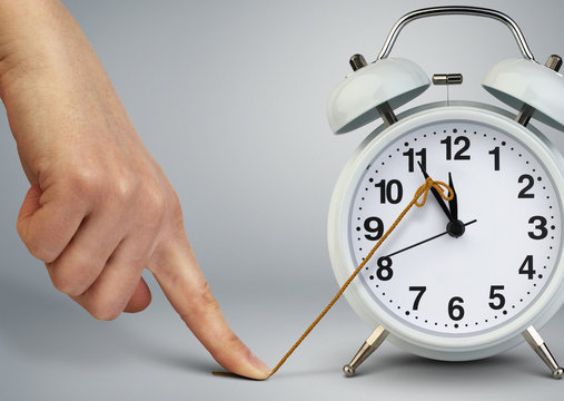 Hand stop time on alarm clock, deadline concept
