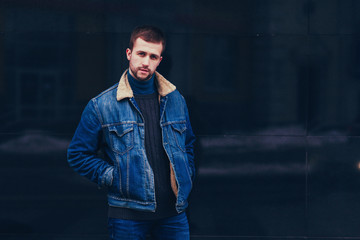 Portrait of a young handsome man fashion model in urban background