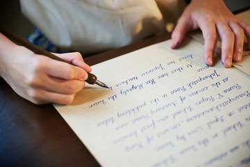 Retro blur effect faded and toned image girl writing a note fountain pen antique handwritten letter page document poet journalist lawyer business plan study contract letter pen memory report