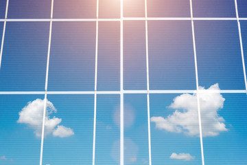 Closeup solar cell panel surface reflected beautiful blue sky and sun's rays