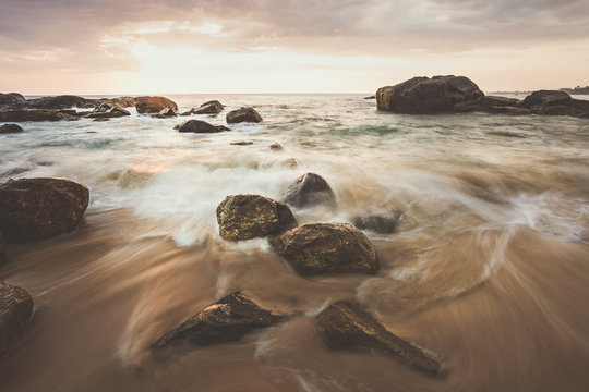 Beautiful sunset at the west coast of Sri Lanka. Great Atmosphere with long exposure and water motion blur.