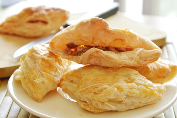 crispy puff stuffed pork sausage and crushed bean with wooden chop block