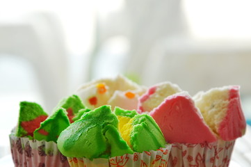 assorted colorful cotton wool cake in paper on plate