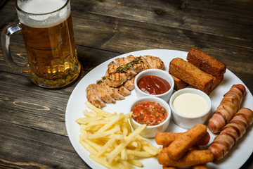 Beer in a glass on wooden background. and snack.