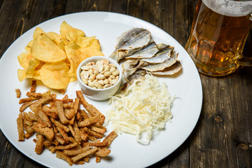 Beer in a glass on wooden background. and snack.