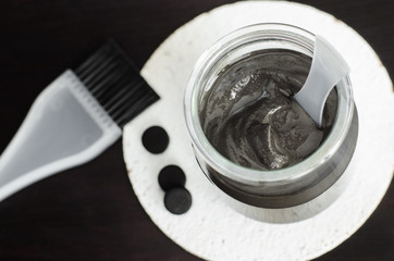 DIY charcoal face and scalp mask in a glass jar. Homemade cosmetics