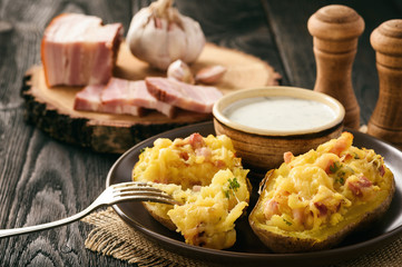 Baked potatoes with bacon, cheese and parsley.