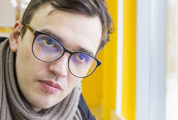 Young man in glasses and scarf