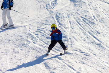 Fototapeta na wymiar Father and son, preschool child, skiing in austrian ski resort in the mountains, wintertime