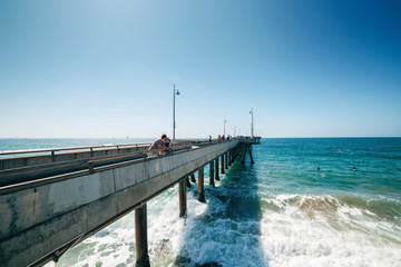 Venice beach pier and the people walking on it in California USA
