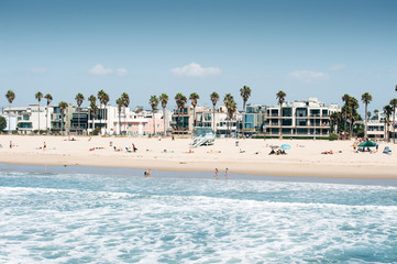 Pacific ocean coastline in Los Angeles USA. People walking at the beach. Rental buildings on Venice beach. © Ayrat A.