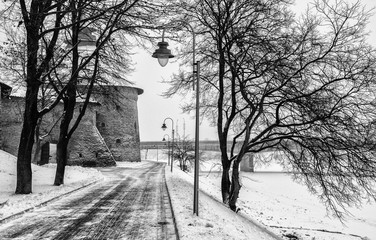 Winter landscape with Pskov intercession tower in the background the snow-covered embankment