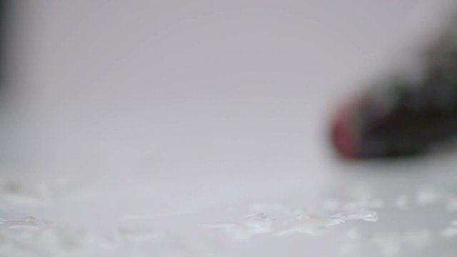 CLOSE UP SLOW MOTION: chef pulls the fish to cook it