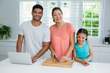 Portrait of parents and daughter in kitchen
