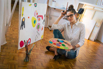 Bringing her creativity to life. Woman painting in her art studio