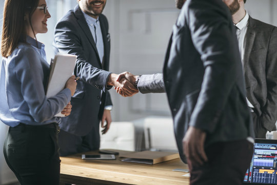 Businessmen shaking hands in office