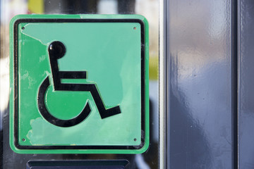 Plate with schematic representation of disabled person in wheelc