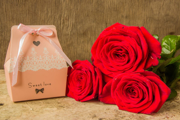 Red roses and gift covered craft paper