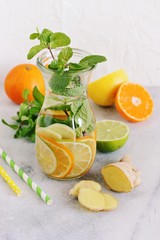 Infused water with citrus fruits,cucumber and ginger.Detox beverages in glass jar and ingredients. Selective focus 