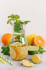 Infused water with citrus fruits,cucumber and ginger.Detox beverages in glass jar and ingredients. Selective focus 