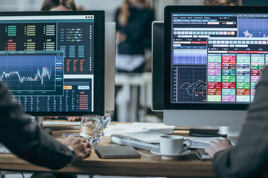 Stock market data on trader's monitors