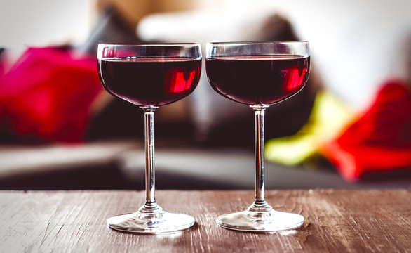 two glasses of red wine on a  table