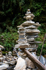 Fototapeta na wymiar Balancing stones near a mountain river in Himalaya
