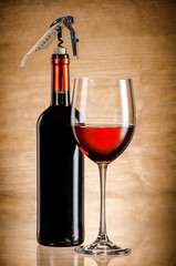 Wine glass and bottle on a wooden background
