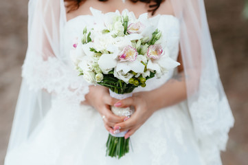 the bride holding a bouquet. wedding flowers. soft focus.