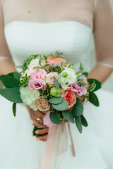 the bride holding a bouquet. wedding flowers. soft focus.