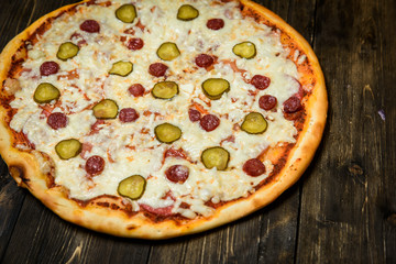 Top view of Italian rustic PIZZA on wooden table background