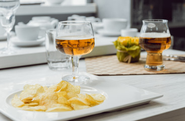 Beer and chips on the large white table