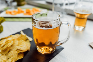 Beer and chips on the large white table