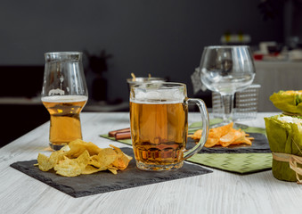 Beer and chips on the large white table