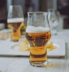 Beer and chips on the large white table