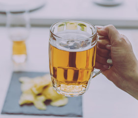 Glass of lager beer in the hands