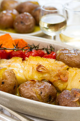 cod fish with potato and tomato cherry on dish