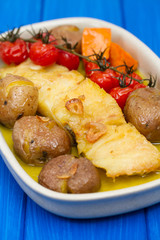 cod fish with potato and tomato cherry on dish