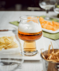 Beer and chips on the large white table