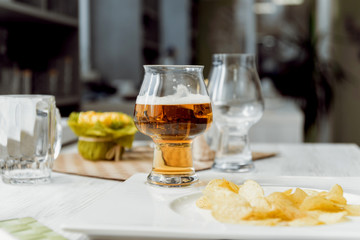 Beer and chips on the large white table